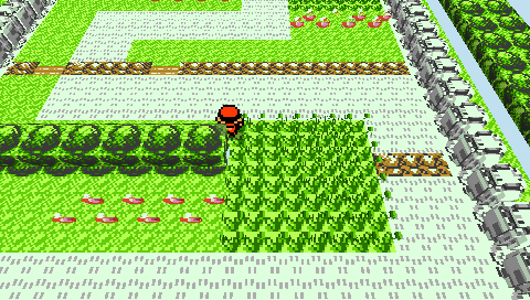 Route 1 on the PSP: the player stands at the edge of tall encounter grass rendered as hundreds of extruded voxel tufts, with rows of carved round trees, a ledge, fences, and flowers.